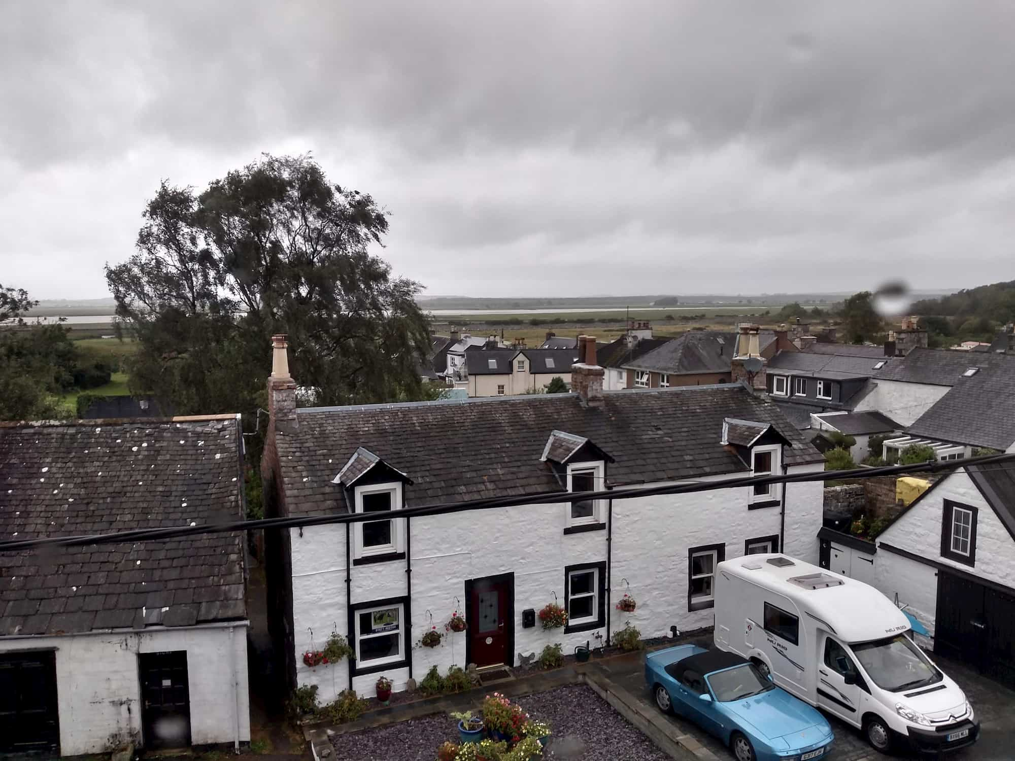 View from hotel room window of rain and a lot of flat empty land stretching out into the distance